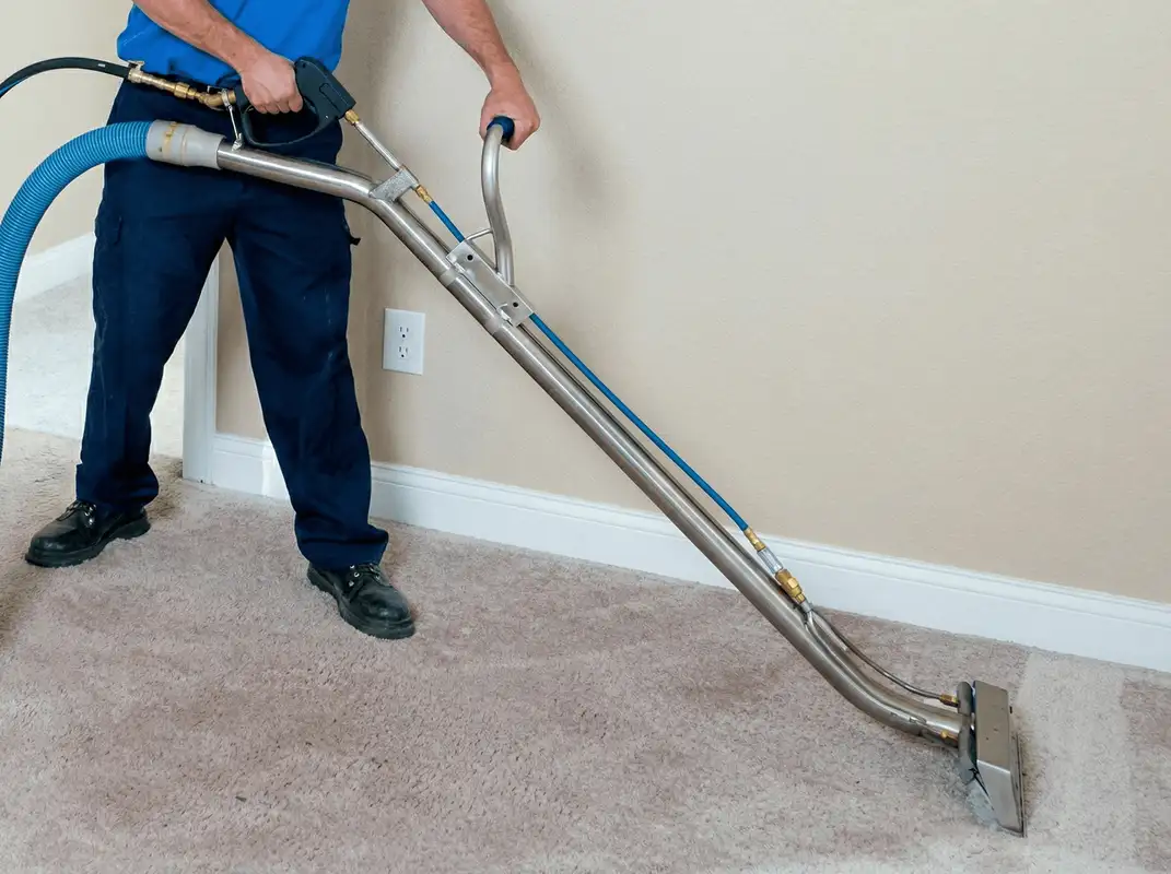 Professional operating a liquid removal machine on a carpeted floor in Anaheim, CA
